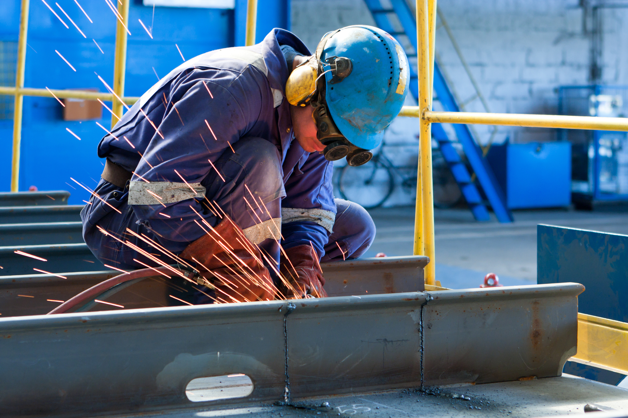 Welding Worker Welds Steel Plate